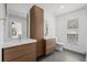 Modern bathroom features dual vanities, a toilet, and wood cabinetry at 1063 Eagles Forrest, Apopka, FL 32712