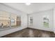 Bright bedroom with wood-look floors, white walls, and two large windows for natural light at 1063 Eagles Forrest, Apopka, FL 32712