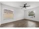 Light-filled bedroom features wood-look floors, a ceiling fan, and ample natural light at 1063 Eagles Forrest, Apopka, FL 32712