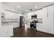 Modern kitchen featuring white cabinets, stainless appliances, and sleek countertops at 1063 Eagles Forrest, Apopka, FL 32712