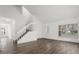 Bright living room featuring wood-look floors, high ceilings, staircase and natural light at 1063 Eagles Forrest, Apopka, FL 32712