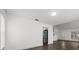 Open-concept room showcases wood-look floors, white walls, stainless refrigerator and bright ambiance at 1063 Eagles Forrest, Apopka, FL 32712