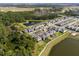 Wide aerial view of a neighborhood with green spaces, lakes and modern homes in a suburban setting at 11206 Pixie Mandarin Ct, Winter Garden, FL 34787