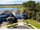 Scenic aerial view of a home near a lake, showcasing well-manicured lawns and community amenities at 11206 Pixie Mandarin Ct, Winter Garden, FL 34787