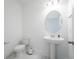Bright powder room featuring a pedestal sink, modern toilet, and stylish fixtures at 11206 Pixie Mandarin Ct, Winter Garden, FL 34787