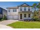 Charming two-story home with a brick driveway, two-car garage, and well-maintained landscaping at 11206 Pixie Mandarin Ct, Winter Garden, FL 34787