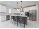 Bright kitchen featuring a center island with seating, stainless steel appliances and modern white cabinetry at 11206 Pixie Mandarin Ct, Winter Garden, FL 34787