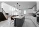 Open-concept kitchen boasts a large island, stainless steel appliances, and seamless flow into dining and living areas at 11206 Pixie Mandarin Ct, Winter Garden, FL 34787