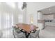 Bright living area with a dining table, modern chairs, and a view of the gourmet kitchen at 11206 Pixie Mandarin Ct, Winter Garden, FL 34787