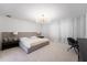 Inviting main bedroom showcasing a plush bed, modern chandelier, and serene ambiance, ideal for relaxation at 11206 Pixie Mandarin Ct, Winter Garden, FL 34787