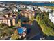 Stunning aerial view of condo community with lakeside pool, fountain, well-manicured green spaces, and neighborhood views at 12521 Floridays Resort Dr # 307F, Orlando, FL 32821
