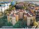 An aerial view of a multi-Gathering complex with a red tile roof surrounded by green trees and other buildings at 12521 Floridays Resort Dr # 307F, Orlando, FL 32821
