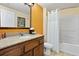 Nicely appointed bathroom features a shower/tub combo, granite counters, and a large vanity mirror at 12521 Floridays Resort Dr # 307F, Orlando, FL 32821