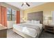 Comfortable bedroom with a large window, stylish curtains, carpeted floors, and modern furniture at 12521 Floridays Resort Dr # 307F, Orlando, FL 32821