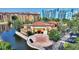 Beautifully landscaped exterior featuring a circular driveway with a star design near a serene lake at 12521 Floridays Resort Dr # 307F, Orlando, FL 32821