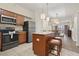 Bright kitchen with an island, seating, stainless steel appliances, and an open view to dining and living areas at 12521 Floridays Resort Dr # 307F, Orlando, FL 32821