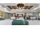 Elegant lobby area with a modern chandelier, reception desk, stylish seating, and contemporary decor at 12521 Floridays Resort Dr # 307F, Orlando, FL 32821