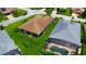 Aerial view features home and manicured lawn, with a screened-in pool in the adjacent lot at 1368 Del Mar Dr, Kissimmee, FL 34759
