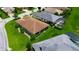 Aerial view showcases a well-maintained home with manicured lawn and screened-in pool nearby at 1368 Del Mar Dr, Kissimmee, FL 34759