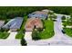 Stunning aerial view of a home featuring a lush lawn, mature trees, and a well-maintained exterior in a desirable neighborhood at 1368 Del Mar Dr, Kissimmee, FL 34759