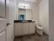 Bathroom featuring tile floor, single sink vanity, a toilet and a large mirror at 1368 Del Mar Dr, Kissimmee, FL 34759