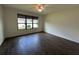 Inviting bedroom with hardwood floors and a large window overlooking the yard at 1368 Del Mar Dr, Kissimmee, FL 34759