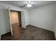 Open-concept bedroom featuring tiled floors, white walls, and an open door to the hallway at 1368 Del Mar Dr, Kissimmee, FL 34759