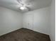 Neutral bedroom features wood-look flooring, a ceiling fan, and a closet with double doors at 1368 Del Mar Dr, Kissimmee, FL 34759