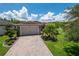 Lovely single-story home showcasing a paved driveway, two-car garage, and well-maintained landscaping at 1368 Del Mar Dr, Kissimmee, FL 34759