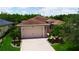Charming single-story home with brick driveway, attached two-car garage, and beautiful landscaping at 1368 Del Mar Dr, Kissimmee, FL 34759