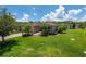 Beautiful single-story home exhibiting a large lawn, paved driveway, and mature trees at 1368 Del Mar Dr, Kissimmee, FL 34759