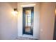 Exterior features a decorative glass front door, black trim, and a wall-mounted light fixture at 1368 Del Mar Dr, Kissimmee, FL 34759
