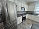 Modern kitchen with stainless steel appliances, granite countertops, and a decorative backsplash at 1368 Del Mar Dr, Kissimmee, FL 34759