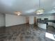 Large open-concept living space with tile floors flowing into the kitchen area with stainless steel appliances at 1368 Del Mar Dr, Kissimmee, FL 34759