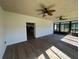 Open sun room featuring two ceiling fans and hardwood flooring at 1368 Del Mar Dr, Kissimmee, FL 34759