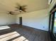Bright sunroom with hardwood floors, ceiling fans, and a door to the outside at 1368 Del Mar Dr, Kissimmee, FL 34759