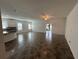 Open-concept living room with tile flooring, fan, and access to the kitchen at 1368 Del Mar Dr, Kissimmee, FL 34759