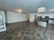 Spacious open floor plan with tile flooring, white walls, and kitchen access at 1368 Del Mar Dr, Kissimmee, FL 34759