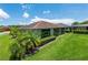 The back of a single-story home reveals manicured lawn and a screened lanai at 1368 Del Mar Dr, Kissimmee, FL 34759