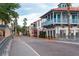 Charming street view showcases colorful townhouses with balconies in a vibrant community at 1368 Del Mar Dr, Kissimmee, FL 34759