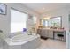Bright bathroom featuring a large soaking tub and vanity area at 15724 Cutter Sail Pl, Winter Garden, FL 34787