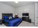 Modern bedroom with sleek black furniture and blue accents at 15724 Cutter Sail Pl, Winter Garden, FL 34787