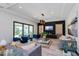 Modern living room featuring tray ceilings, neutral tones, and a sliding glass door at 15724 Cutter Sail Pl, Winter Garden, FL 34787