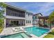 Relaxing backyard oasis featuring a large pool, spa, sun shelf, and covered patio with outdoor seating at 15724 Cutter Sail Pl, Winter Garden, FL 34787