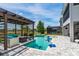 Beautiful pool with a pergola, spa, screened patio, and a blue basketball hoop at 15724 Cutter Sail Pl, Winter Garden, FL 34787