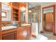 Bathroom with a double sink vanity, granite countertops, and an enclosed tiled shower at 1612 E Washington St, Orlando, FL 32803