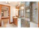 Bright bathroom featuring dual sink vanity, granite counters, a glass shower, and wood trim at 1612 E Washington St, Orlando, FL 32803