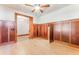 Bedroom featuring wood paneling, hardwood floors, and doorway into adjoining room at 1612 E Washington St, Orlando, FL 32803