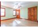 Comfortable bedroom with ample natural light features a ceiling fan, hardwood floors, and closet at 1612 E Washington St, Orlando, FL 32803
