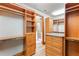 Spacious walk-in closet with custom shelving, storage, and access to bathroom at 1612 E Washington St, Orlando, FL 32803